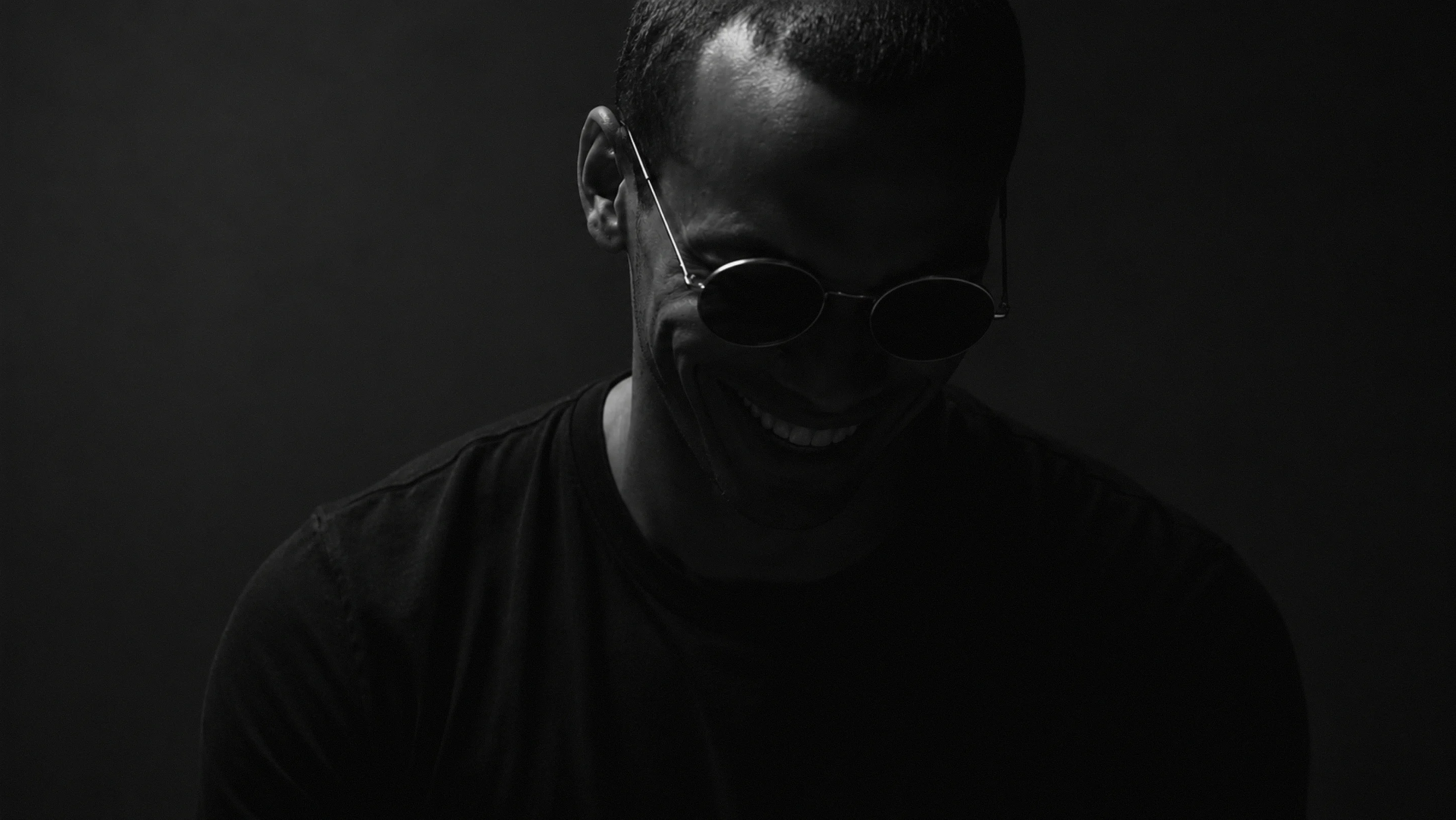 Black and white portrait of Jonas wearing sunglasses